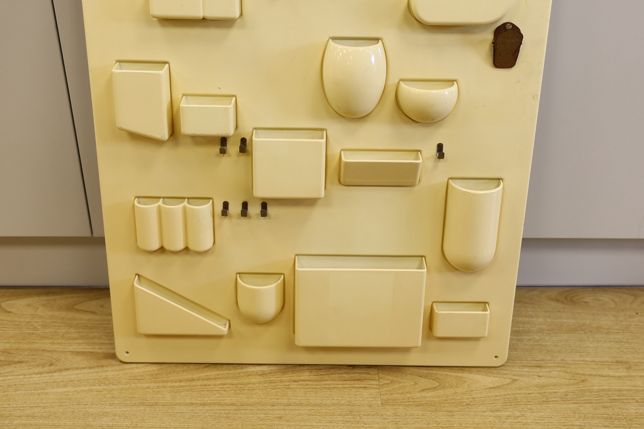 A moulded 20th century Italian composite wall hanging pocket store, 87x67cm